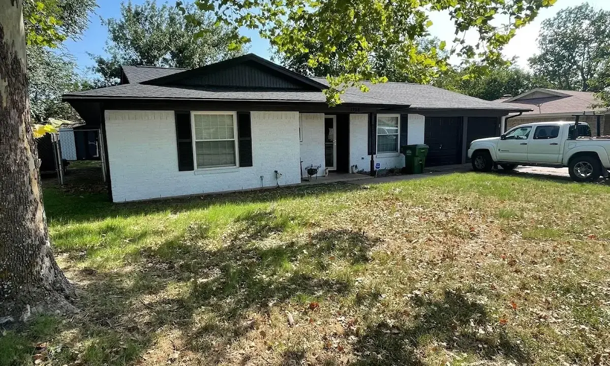 Professional roofing crew working on a residential roof in Marcellus